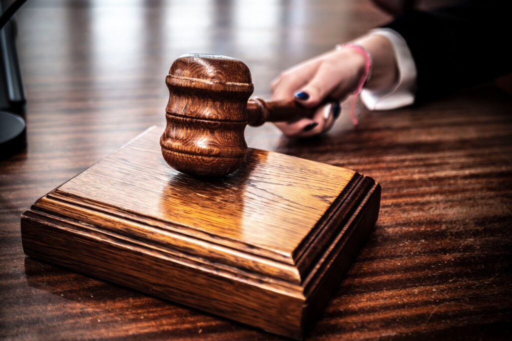 Close-up of a wooden gavel on a judge's desk, symbolizing justice.